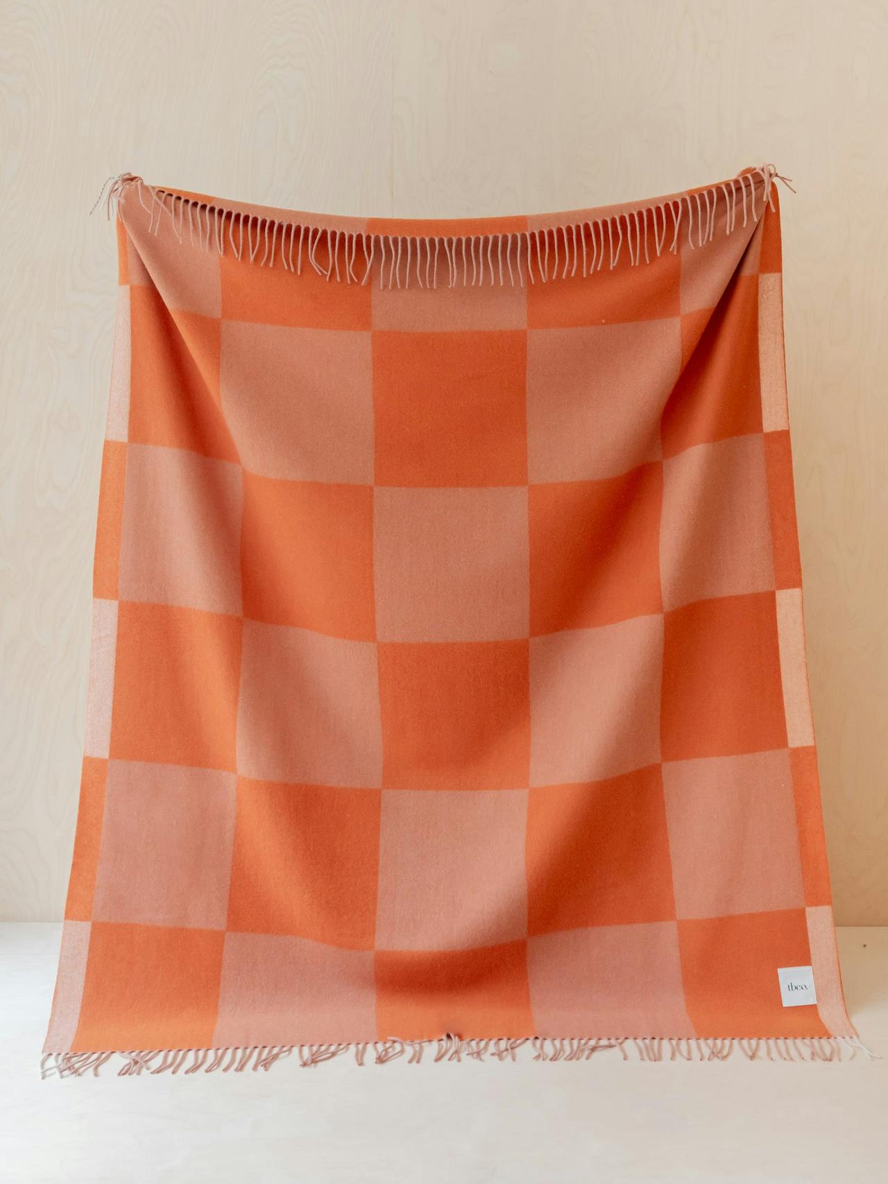 Cashmere and merino blanket in apricot checkerboard